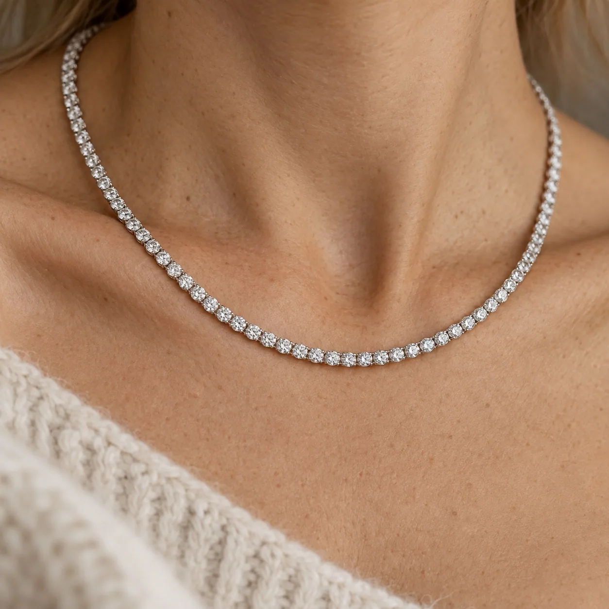 A diamond tennis necklace worn at the collarbone