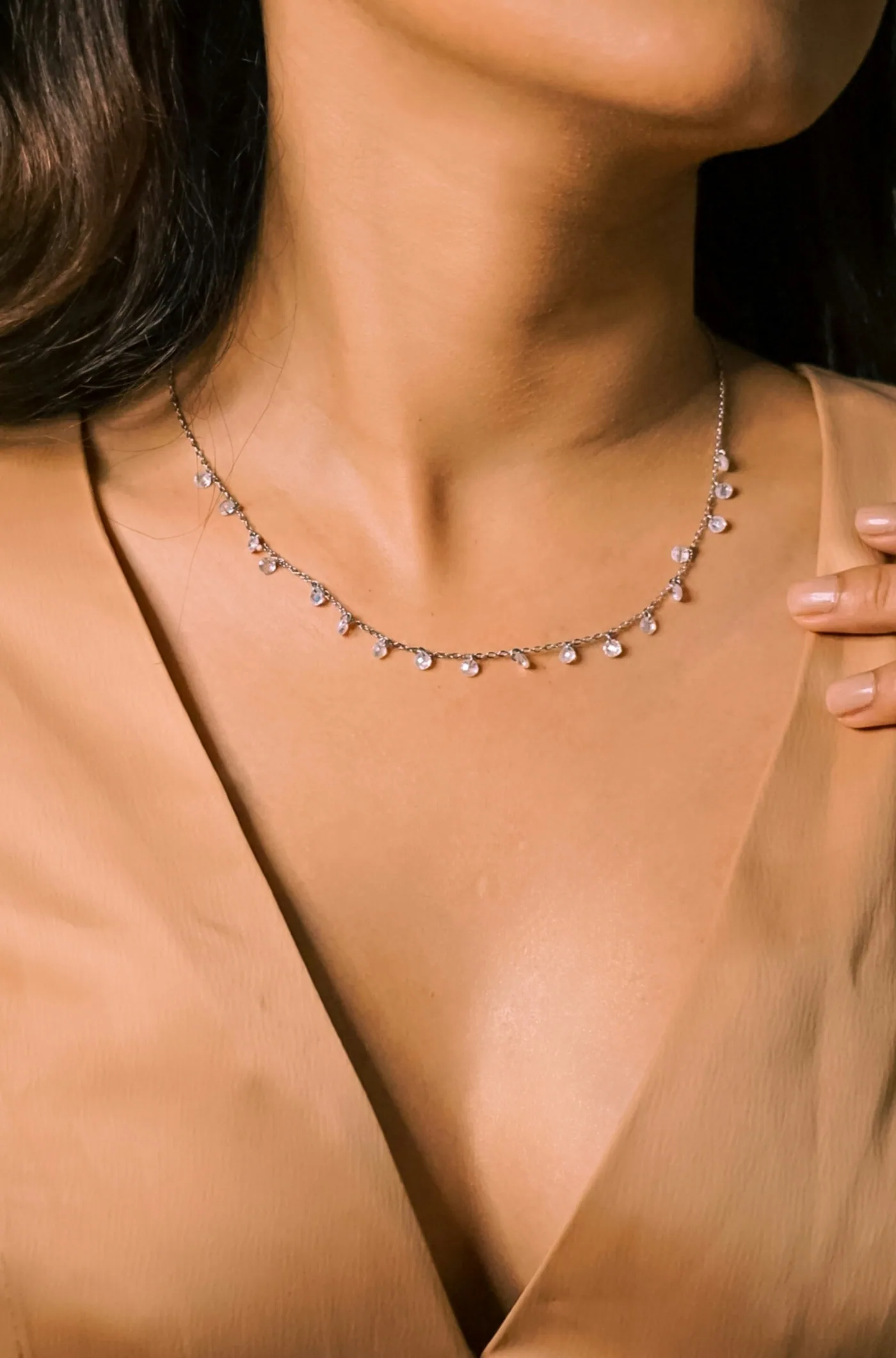A solitaire diamond pendant on a fine chain