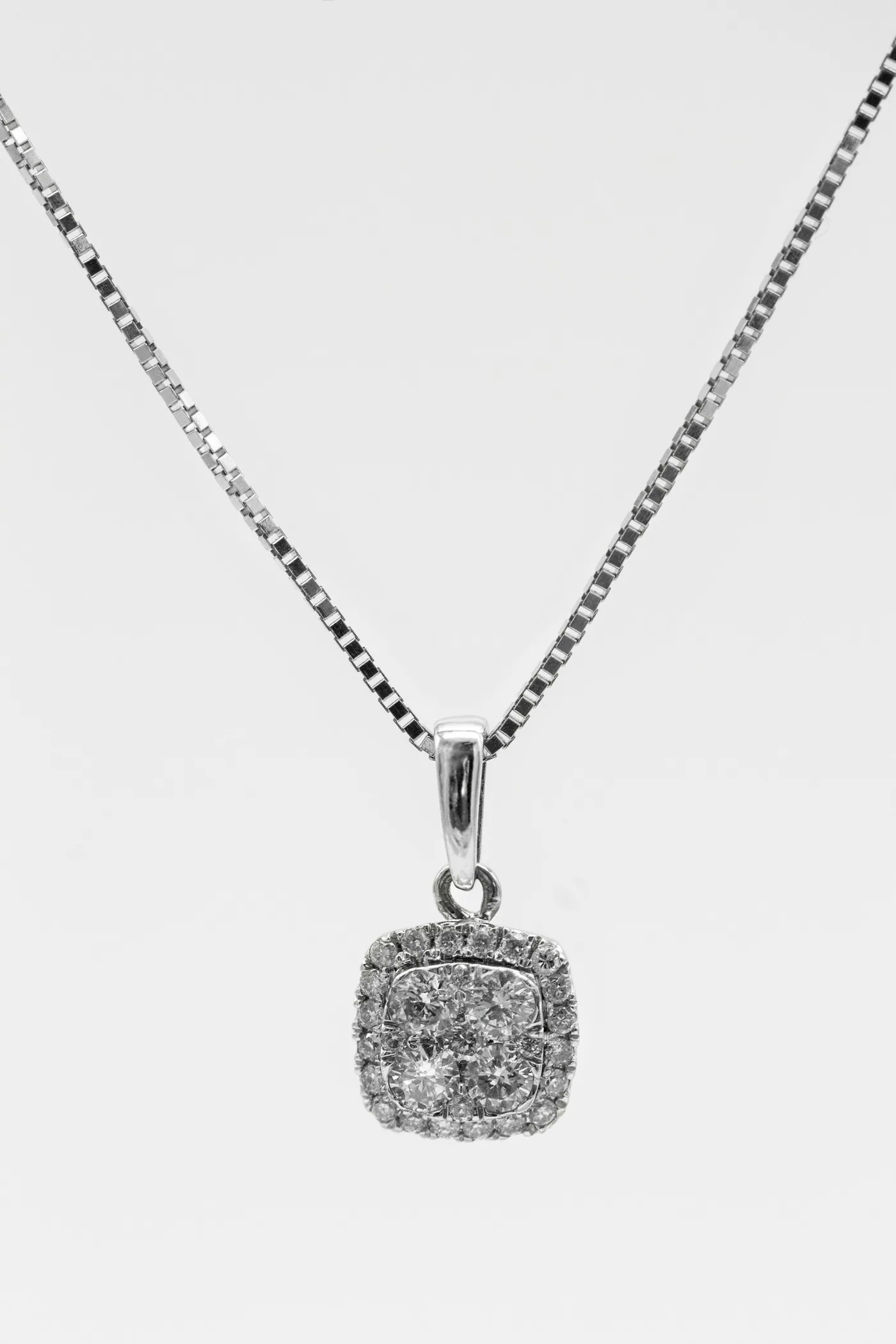 A diamond pendant on a fine chain