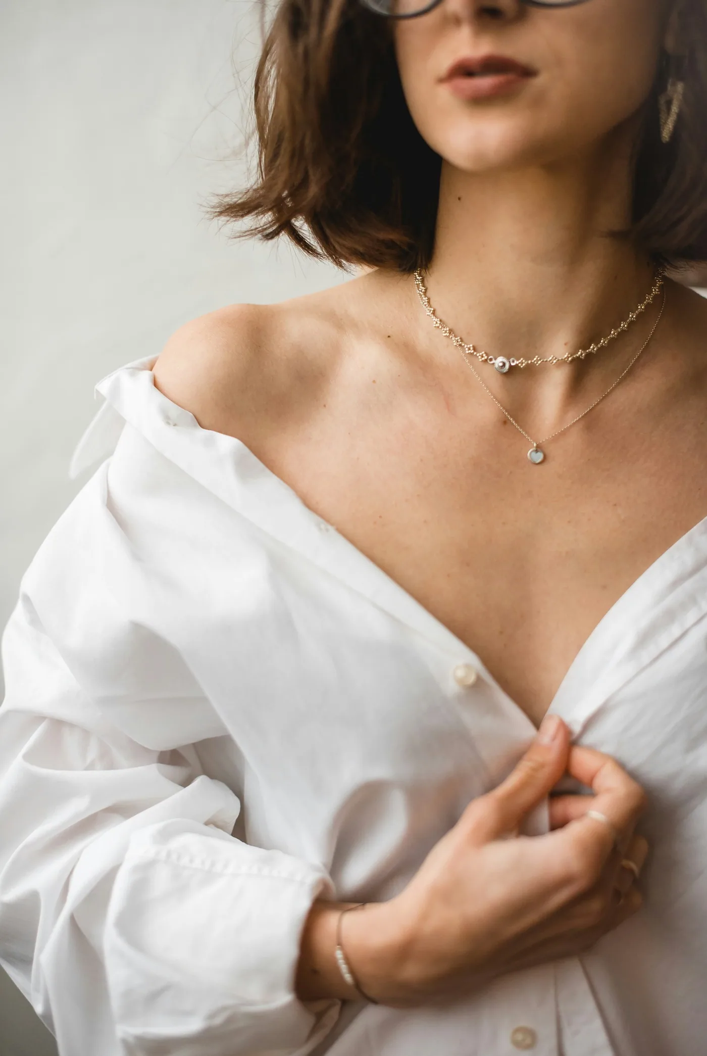 Layered diamond necklaces at the collarbone