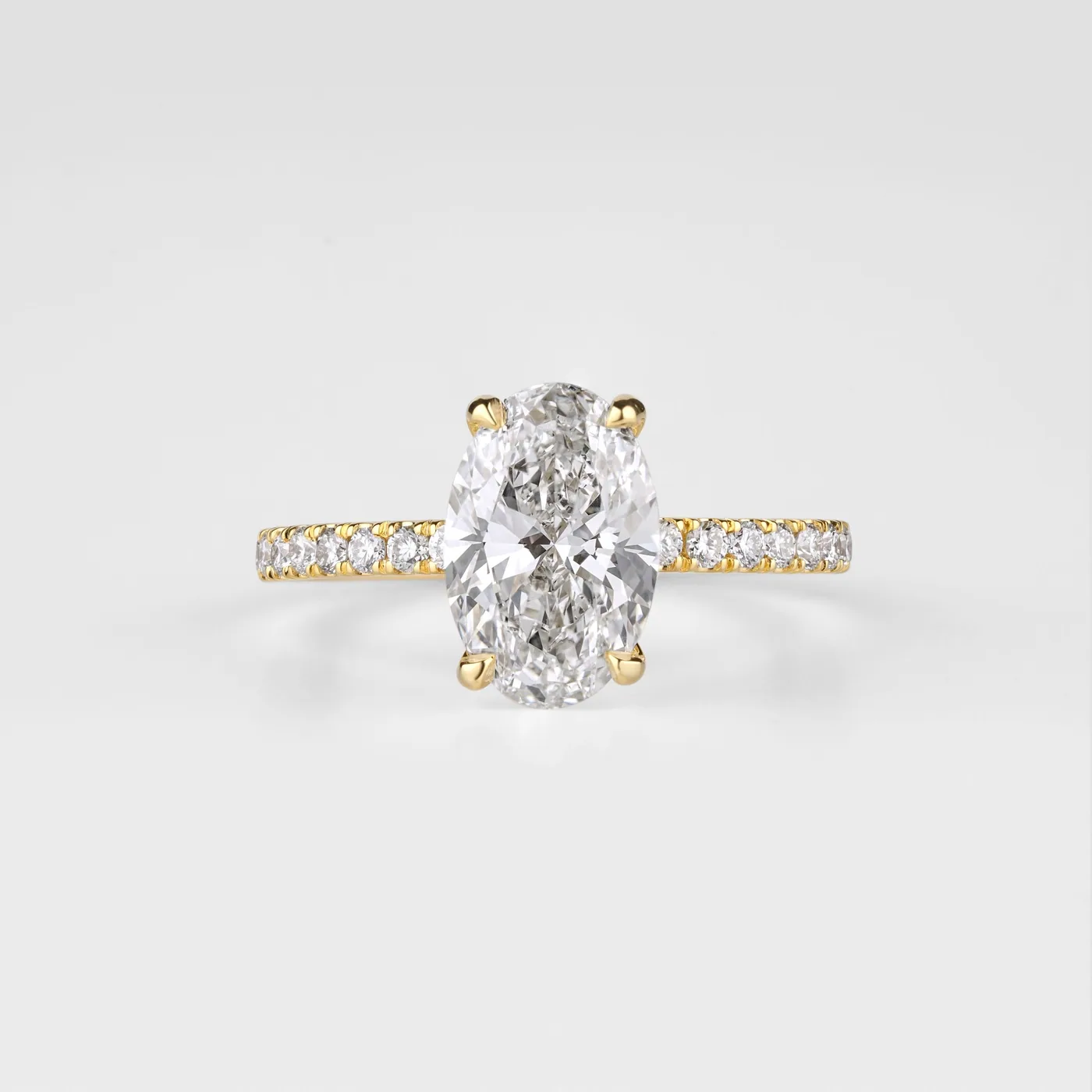 An oval diamond ring with a pavé band