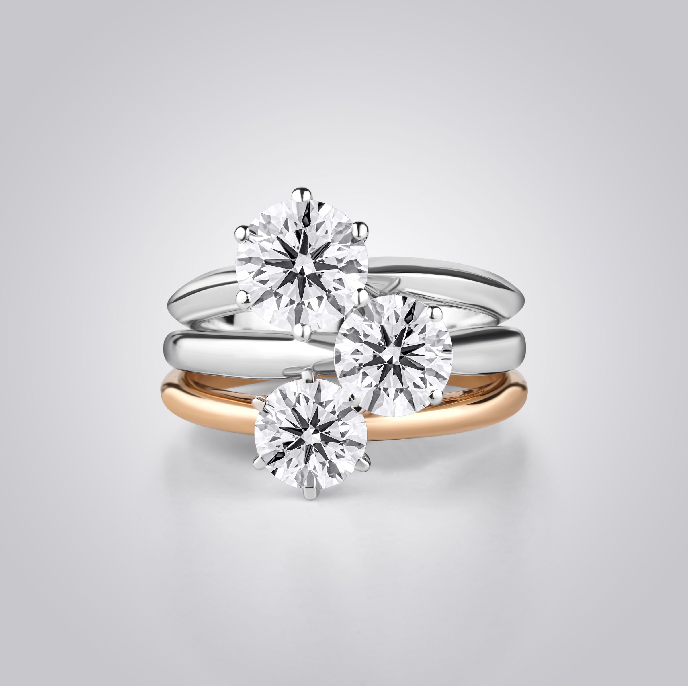 Three stacked diamond rings in white and rose gold